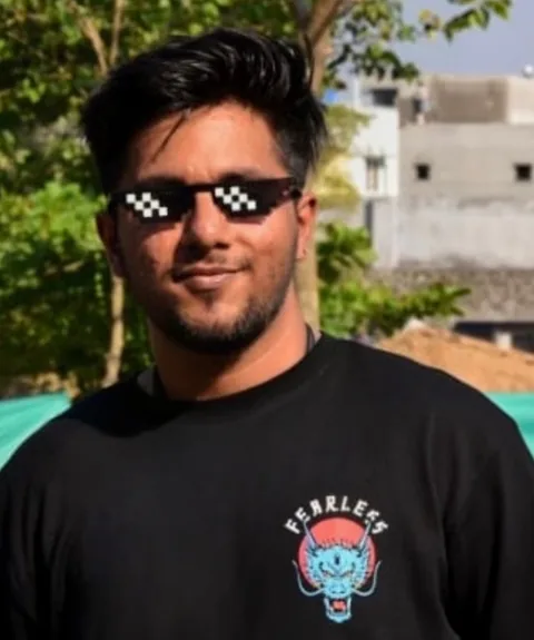 Daksh Bagga smiling outdoors in pixel-art sunglasses and a black T-shirt